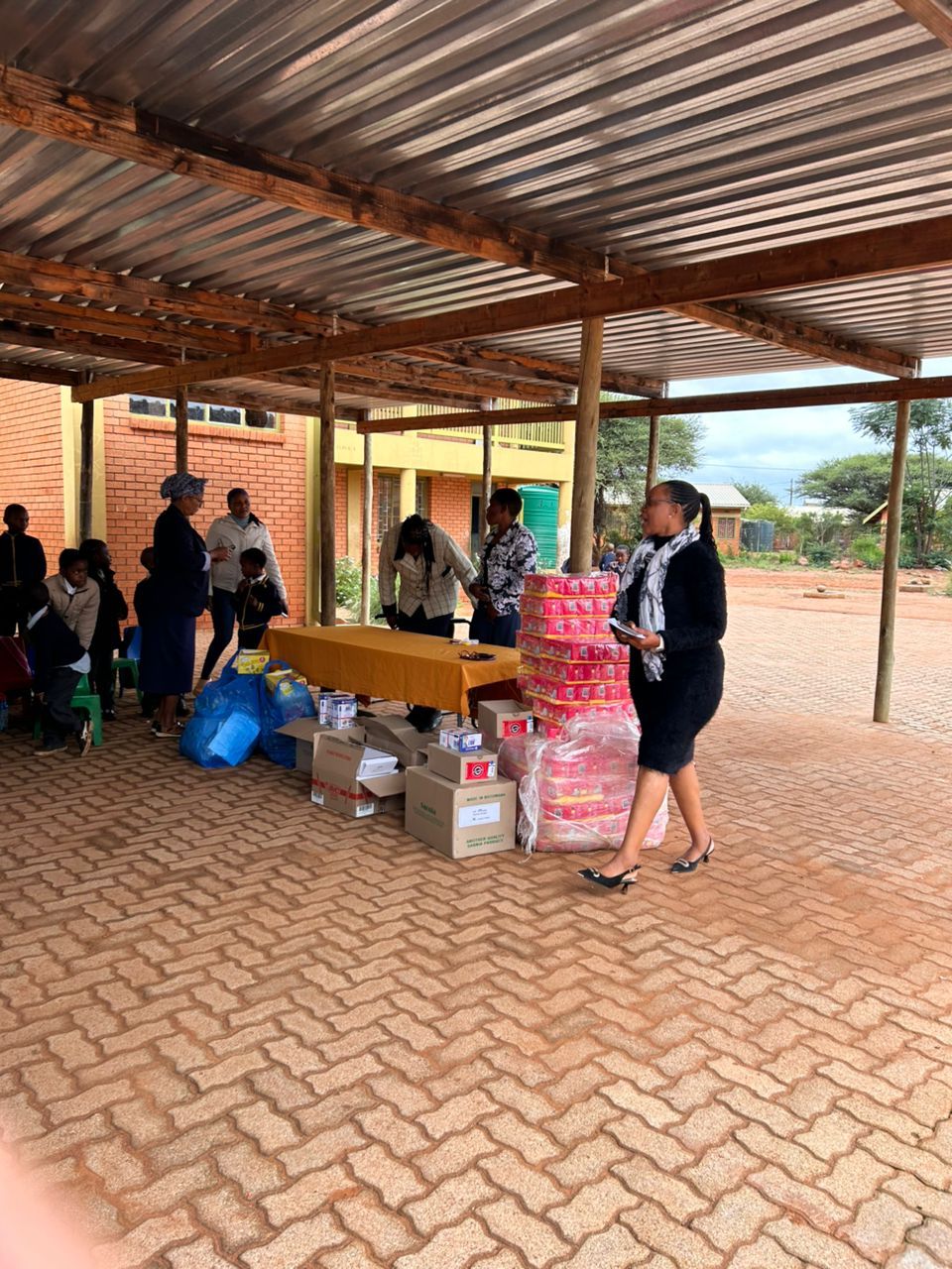 A learner receives a certificate during a donation handover